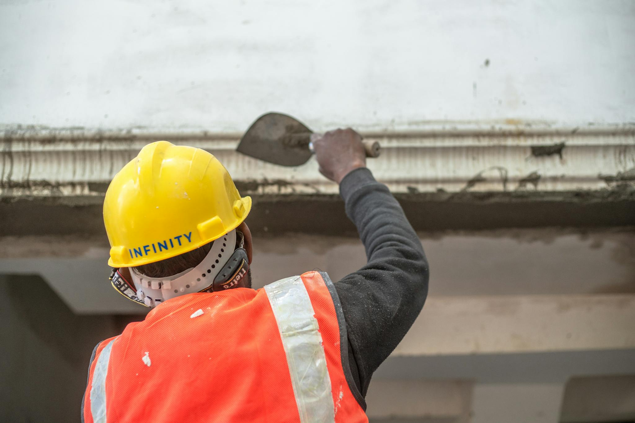 Home A Construction Worker In Safety Gear Renovating An Interior Wall In Delhi India. 30580529 2048x1365