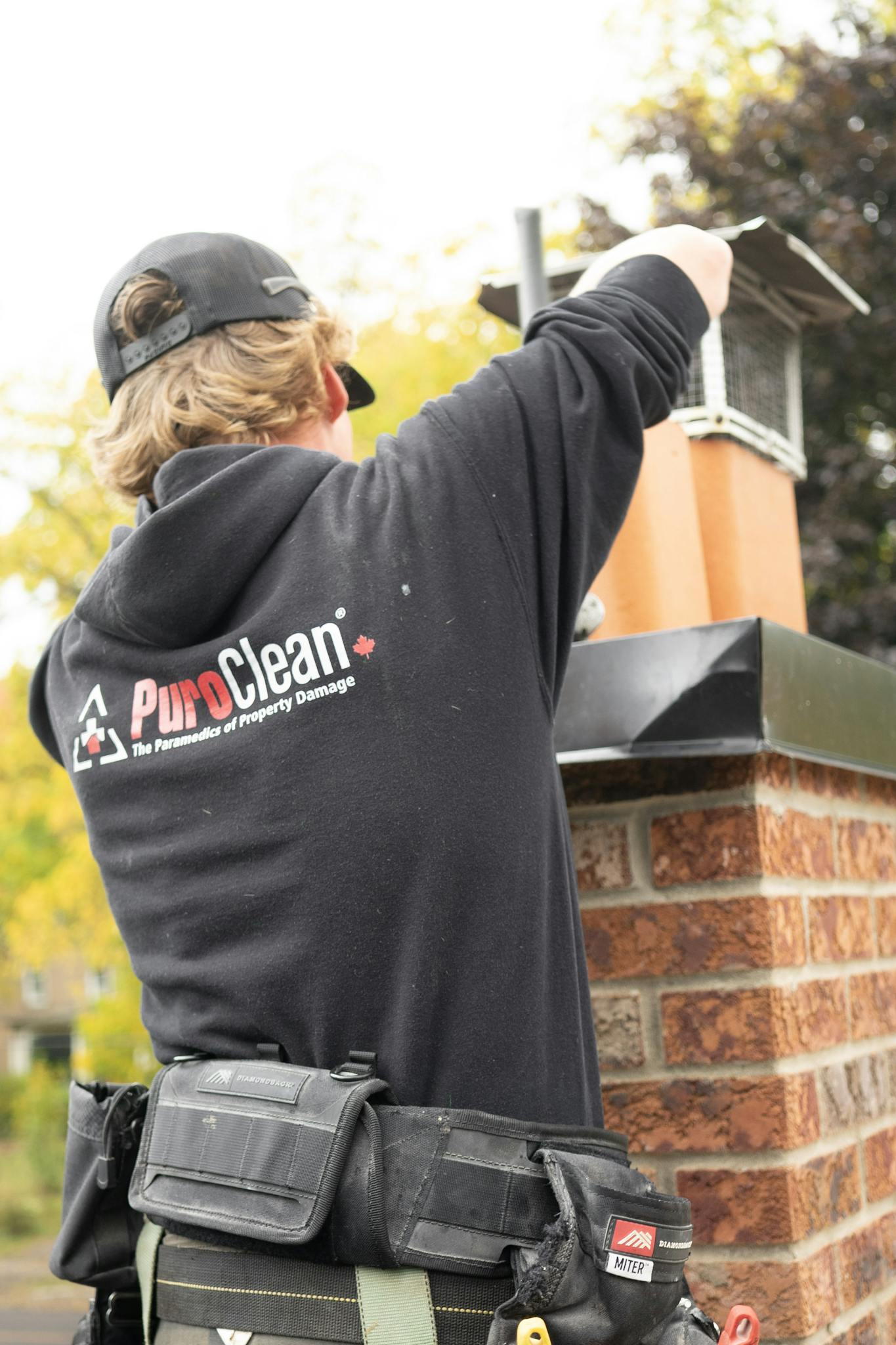 About A technician from PuroClean cleans a chimney as part of property restoration services.