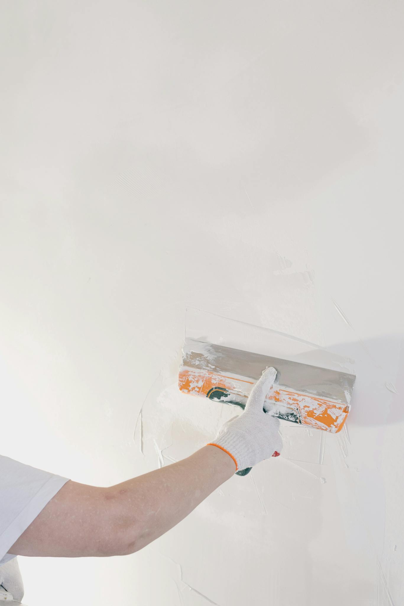 About Close Up Of A Gloved Hand Plastering A Wall With A Spatula In A Home Renovation Setting. 5691637 1367x2048