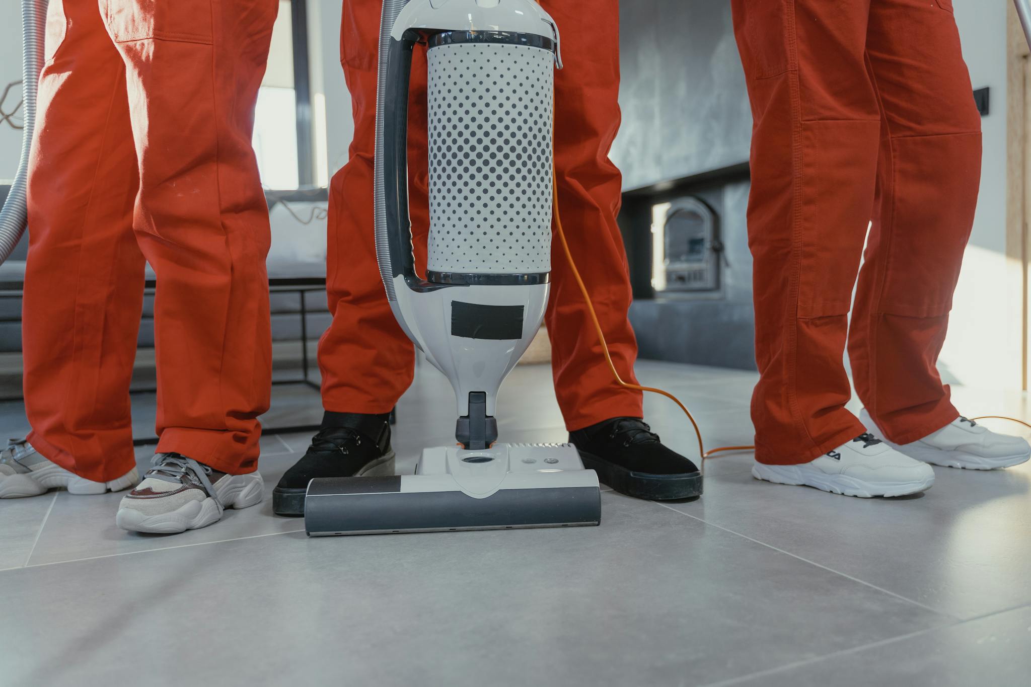 Reviews Team Of Professional Cleaners In Red Uniforms Using A Vacuum Cleaner Indoors. 6195122 2048x1365